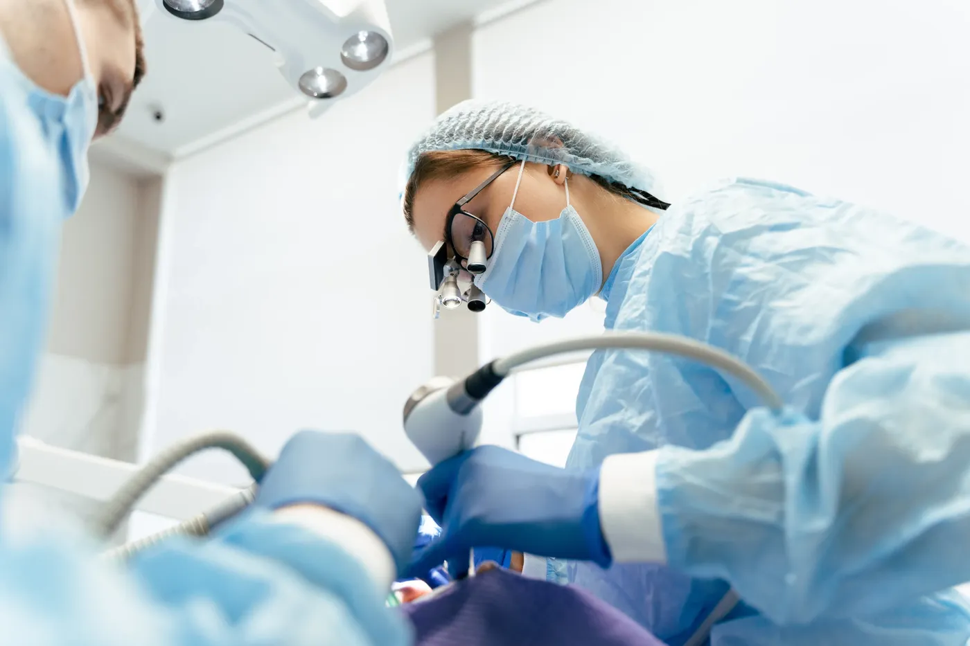 Dental surgeon performing a wisdom teeth extraction procedure